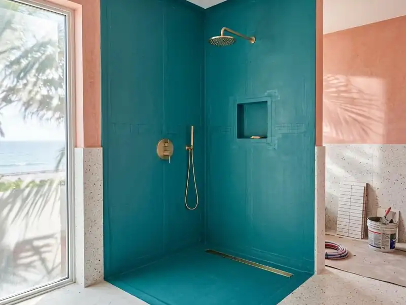 Shower under construction with a waterproof membrane covering walls and floor before tile